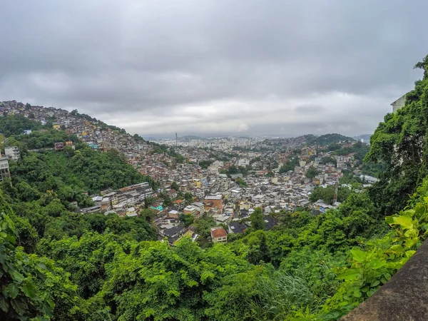 city of rio de janeiro seen from the top of the neighborhood of santa tereza on a cloudy day.