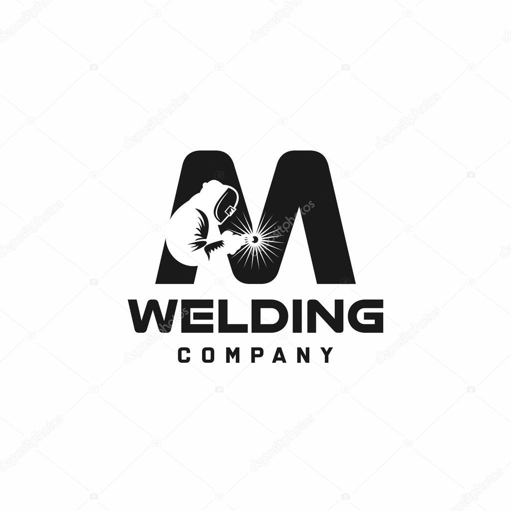 Letter M welding logo, welder silhouette working with weld helmet in simple and modern design style