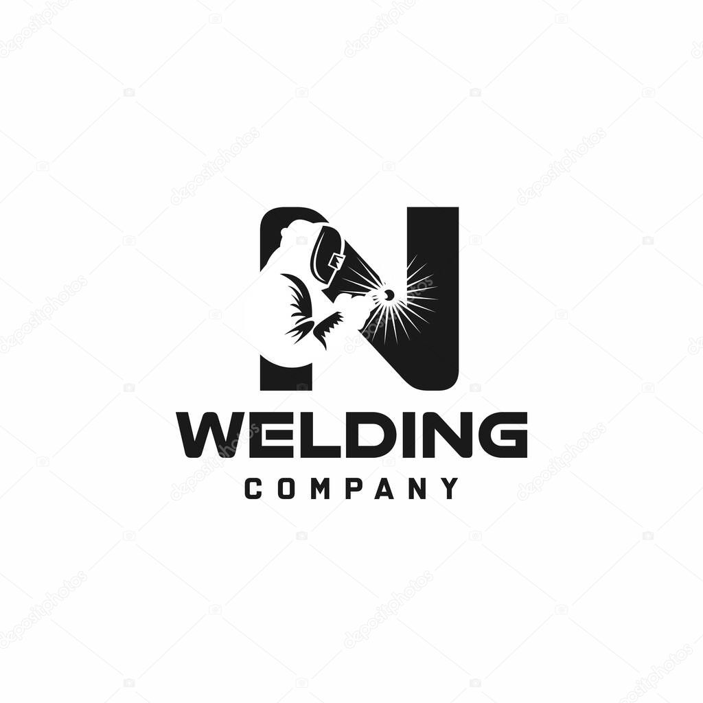 Letter N welding logo, welder silhouette working with weld helmet in simple and modern design style
