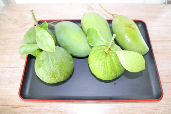 Yapraklı Bir Dalda Yeşil Sulu Mango Portakal — Stok fotoğraf