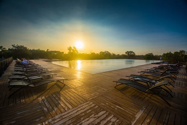 Empty beach chairs in sunset — Stock Photo, Image