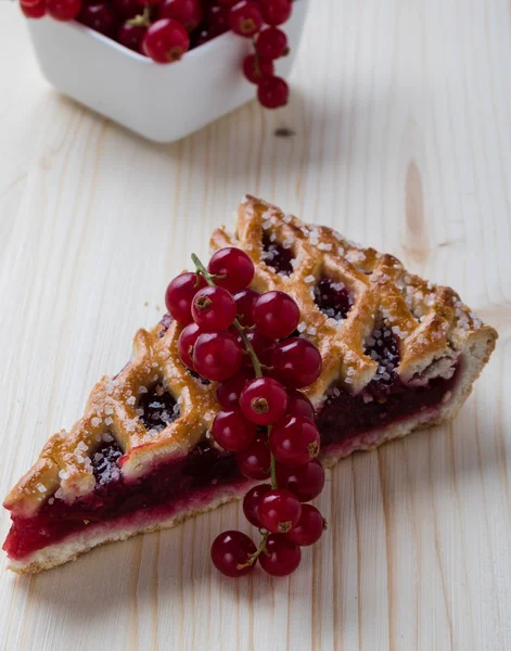 Cherry pie with currant on wooden table — Stock Fotó