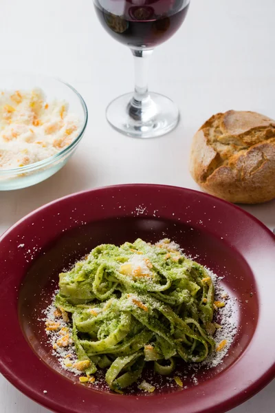 Tagliatelle dish in red plate — Stock Photo, Image