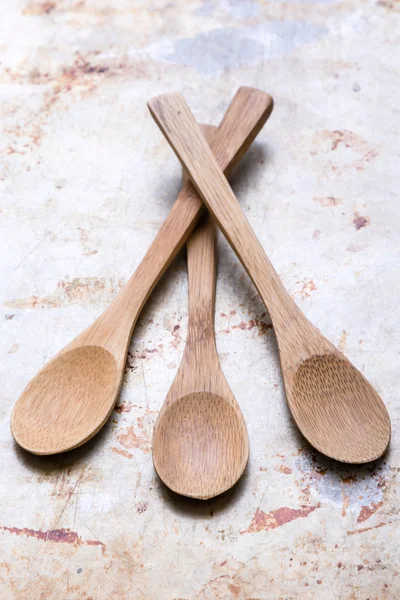 Wooden spoons on steel plate — Stock Photo, Image