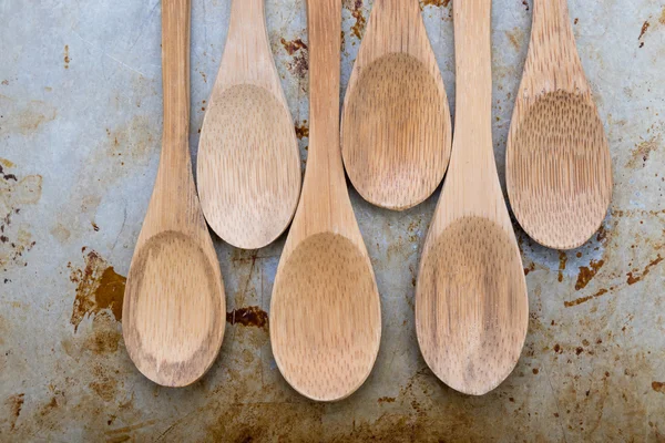 Wooden spoons on steel plate — Stock Photo, Image