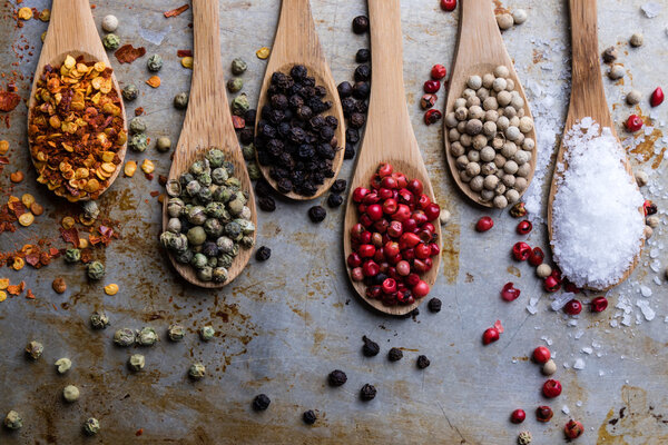 colorful spices in wooden spoons