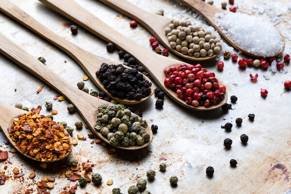 colorful spices in wooden spoons