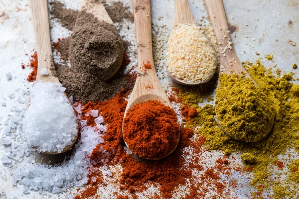 Spices in wooden spoons — Stock Photo, Image