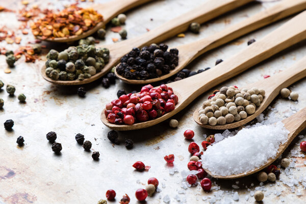 colorful spices in wooden spoons