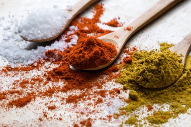 tuz, kırmızı biber ve köri tahta kaşıklar üzerinde