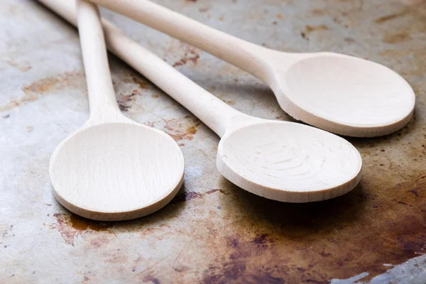 Wooden spoons on steel plate — Stock Photo, Image