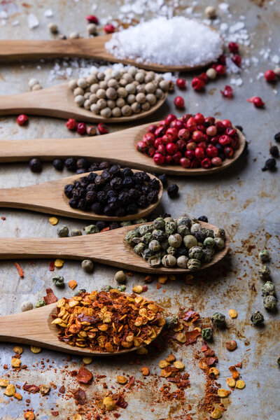 colorful spices in wooden spoons