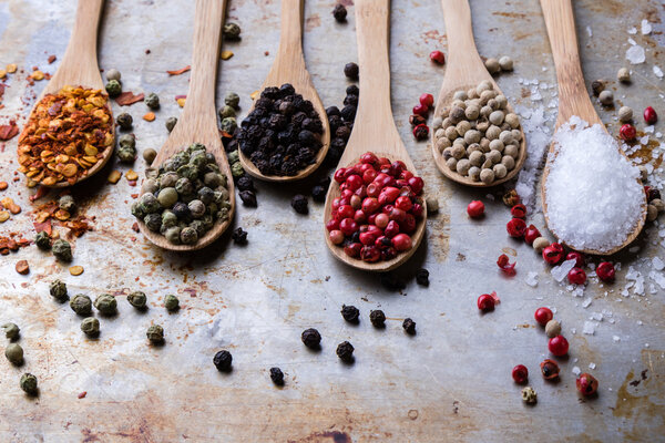 colorful spices in wooden spoons