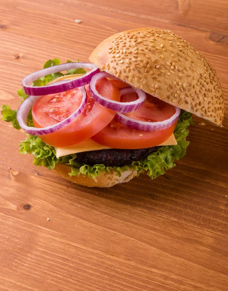 Homemade hamburger on wooden table — Stock Photo, Image