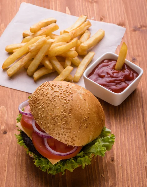 Homemade hamburger on wooden table with fries — Stock Photo, Image