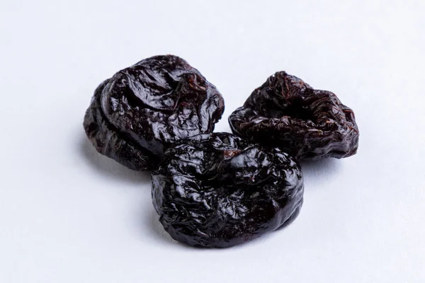 Prunes on white table — Stock Photo, Image