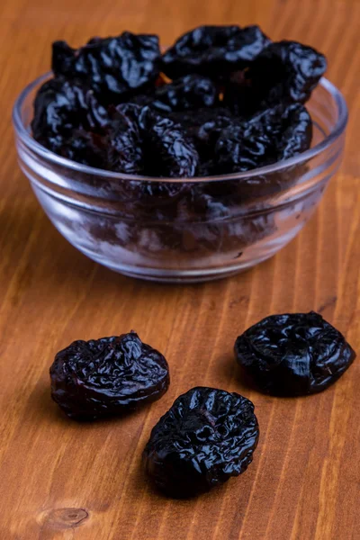Prunes on wooden table — Stock Photo, Image