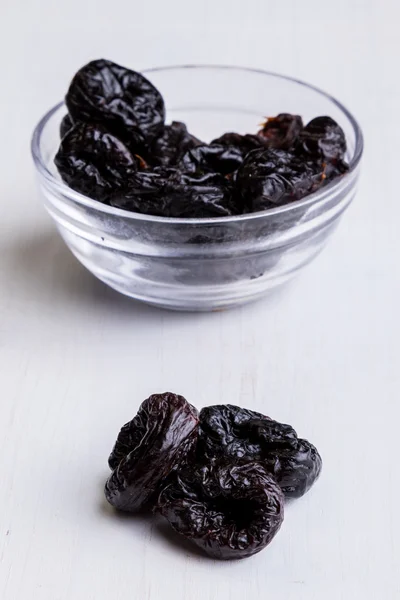 Prunes on white table — Stock Photo, Image