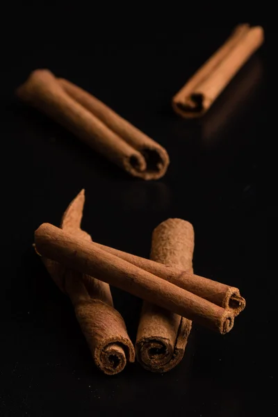 Cinnamon sticks on black table — Stock Photo, Image