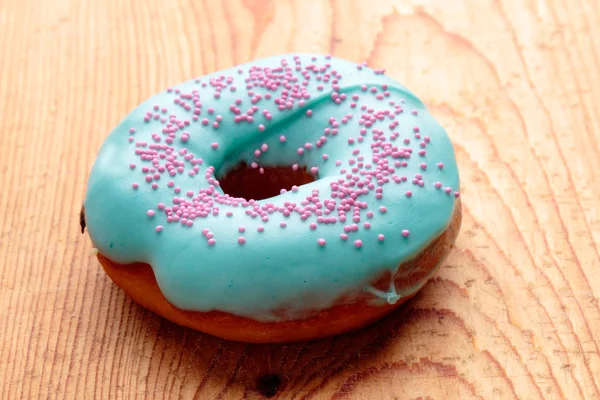 Donut with turquoise frosting — Stock Photo, Image