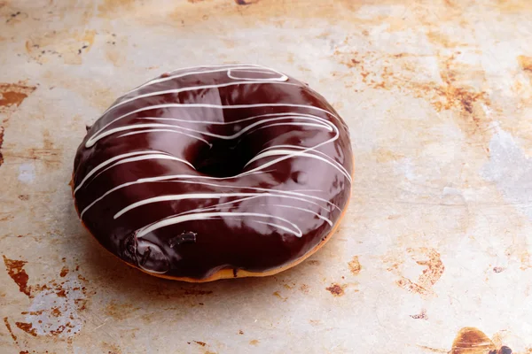 Chocolate donut on steel plate — Stock Photo, Image