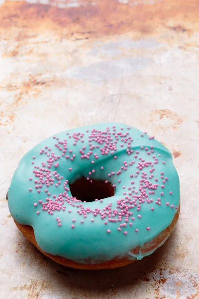 Donut with turquoise frosting — Stock Photo, Image