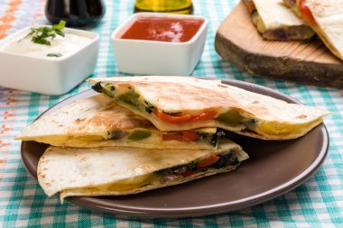 Quesadilla dilimleri kahverengi plaka üzerinde