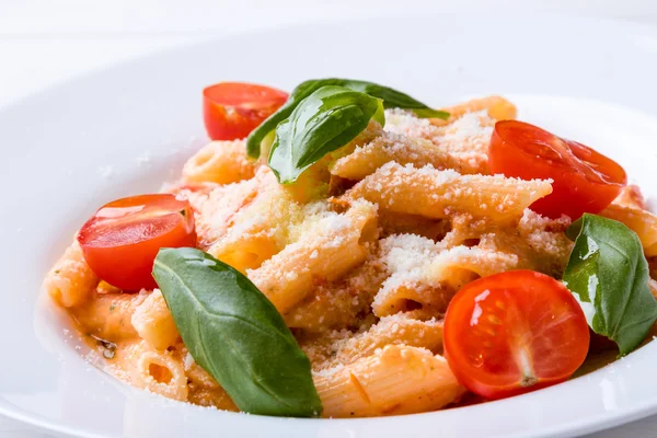 Penne with tomato in white plate — Stock Photo, Image