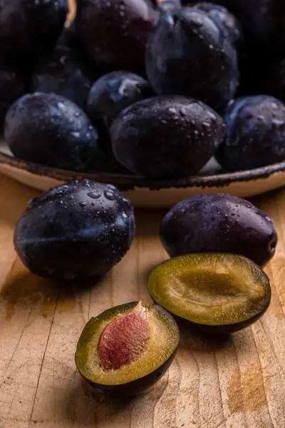 Fresh plums on wooden table — Stock Photo, Image