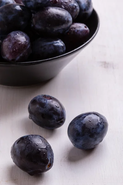 Fresh plums on white table — Stock Photo, Image