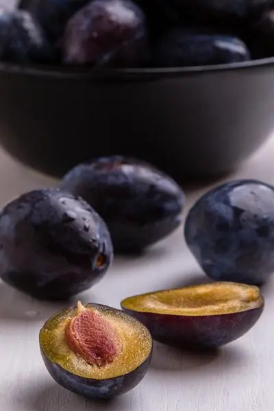 Fresh plums on white table — Stock Photo, Image