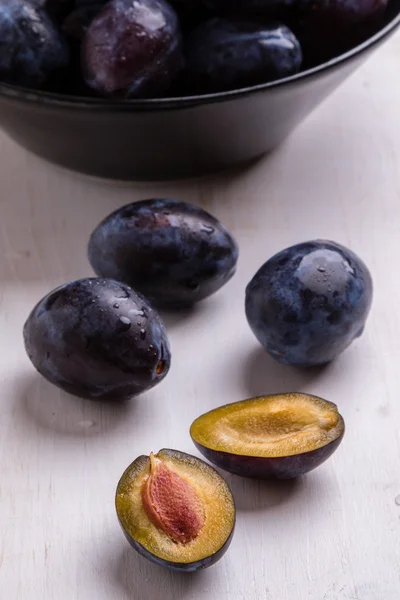 Fresh plums on white table — Stock Photo, Image