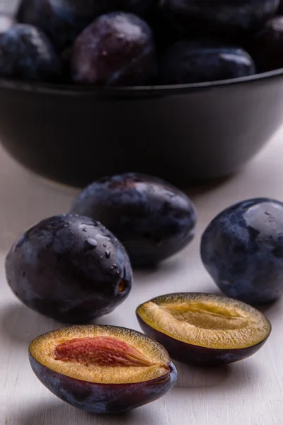 Fresh plums on white table — Stock Photo, Image