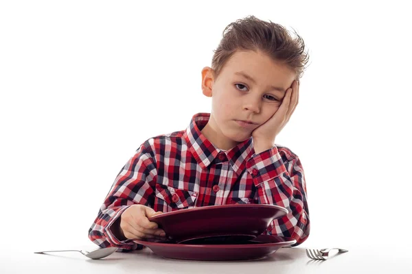 Tired boy at dining table — Stock Photo, Image