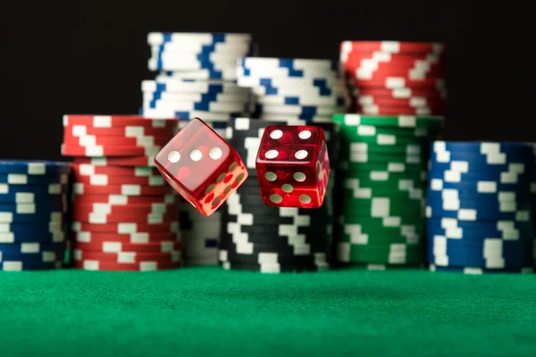 Red dices in air and poker chips — Stock Photo, Image