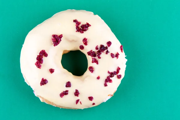 Doughnut on green table — Stock Photo, Image