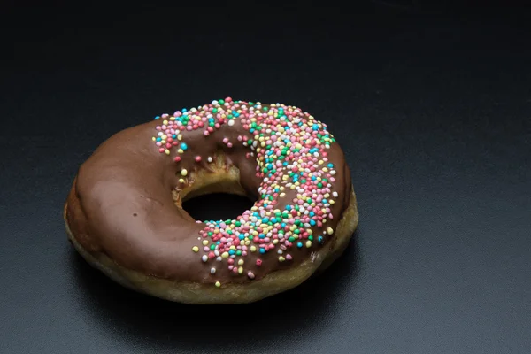 Doughnut with color sprinkles — Stock Photo, Image