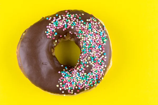 Doughnut on yellow table — Stock Photo, Image