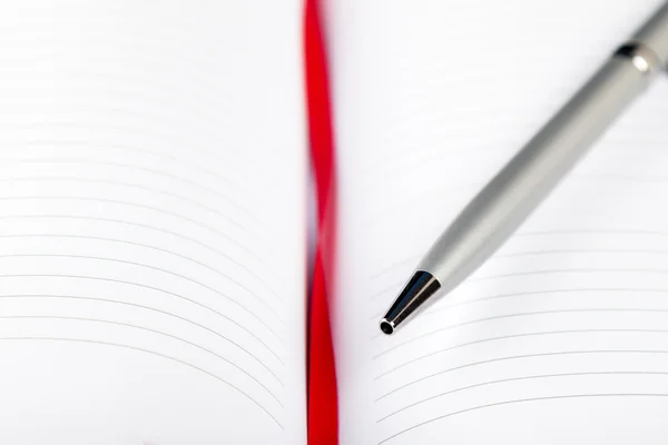 Pluma en cuaderno con cuerda roja — Foto de Stock