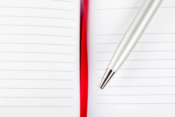 Pluma en cuaderno con cuerda roja — Foto de Stock