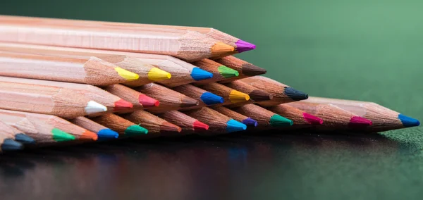 Kleur potloden met groene achtergrond — Stockfoto