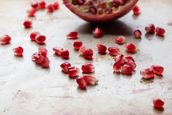 Pomegranate on steel plate — Stock Photo, Image