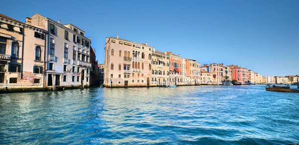 Historic houses, traditional architecture reflected in sea water on Grand Canal in Venice, Italy.