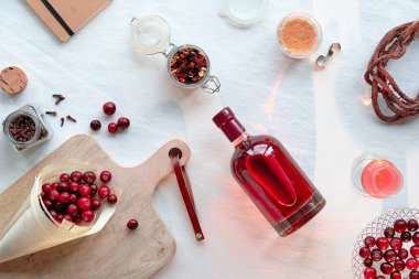 Ev yapımı yaban mersini tentürü. Ev yapımı alkollü içecek hazırlığı. Kuru otlar, kamış şekeri ve baharatlarla dolu sıfır atık cam kavanozlar. Kendi yaptığım alkollü böğürtlen içecekleri konsepti.