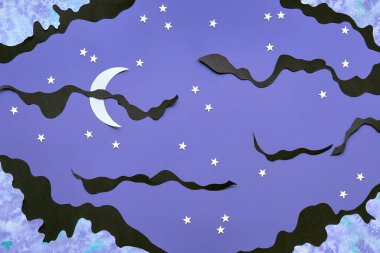 Night background with black clouds, Moon and stars cut from paper. Creative top view. Concept flat lay for quality of sleep topic, quiet night time with sweet dreams.