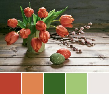 Color matching palette from image of red tulips, Easter eggs and pussy willow twigs. Springtime decorations on rustic wooden background. Retro toned picture of Easter decorations.