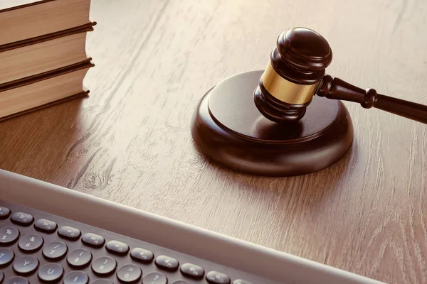 Law hammer, computer keyboard and stack of books. Concept of legal advice, consultation, counseling online, with social distancing.