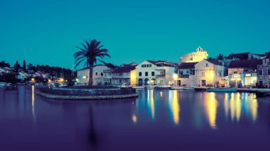 Akşam, Vrboska köyü, Hvar adası, Dalmaçya, Hırvatistan, Avrupa. Rıhtımdaki tekneler ve geleneksel evler. Seyahat tatil beldesi. Eski balıkçı köyü, seyahat yeri..