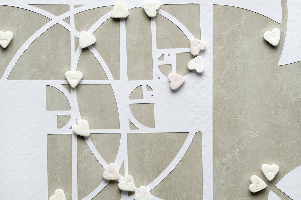 Fibonacci sequence circles and sugar hearts on beton stone background. Sweet taste perfection. Golden ratio concept. Flat lay, geometric paper art. Desaturated, earth colored white, beige colors.