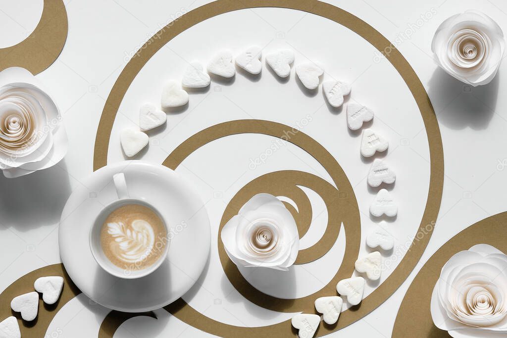 Coffee cup, Fibonacci sequence circles made of brown paper and sugar hearts. Latte art with floral design, tasty perfection. Golden ratio concept, paper art. Top view, flat lay in white and brown.